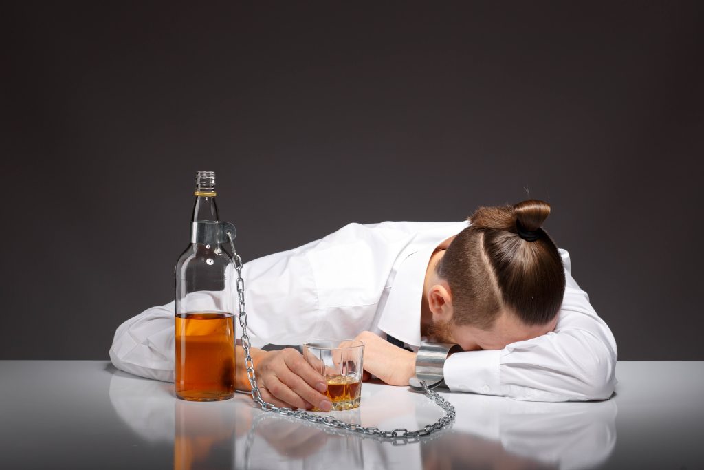 tired-young-businessman-drinking